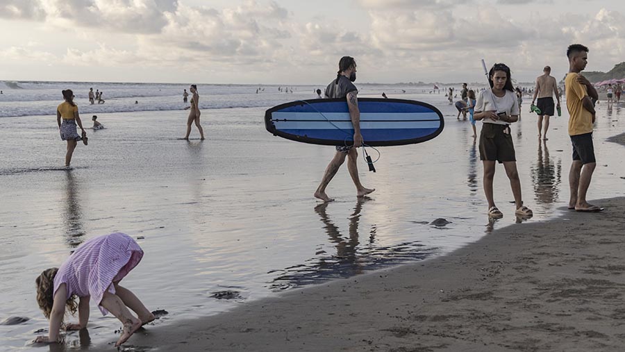 Visitors at Double Six beach in Seminyak, Bali, Indonesia, on Tuesday, Dec. 26, 2023. Indonesia plans to let more nationalities enter the country without visas, reversing an earlier tightening of entry rules, to attract more tourism spending. Nyimas Laula